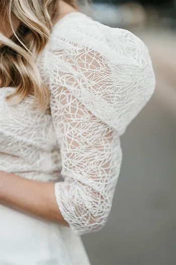 Detail of the puffed sleeve on bride's Rime Arodaky wedding dress