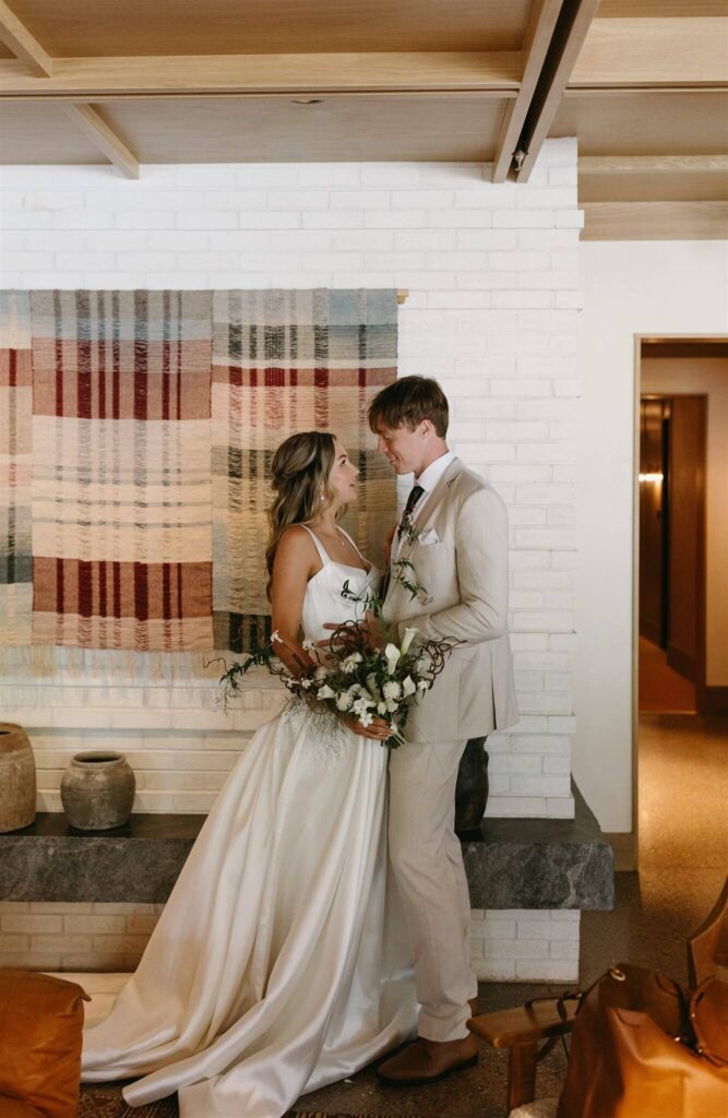 Bride and groom share an intimate moment in the lobby of the MOLLIE Aspen wedding venue.