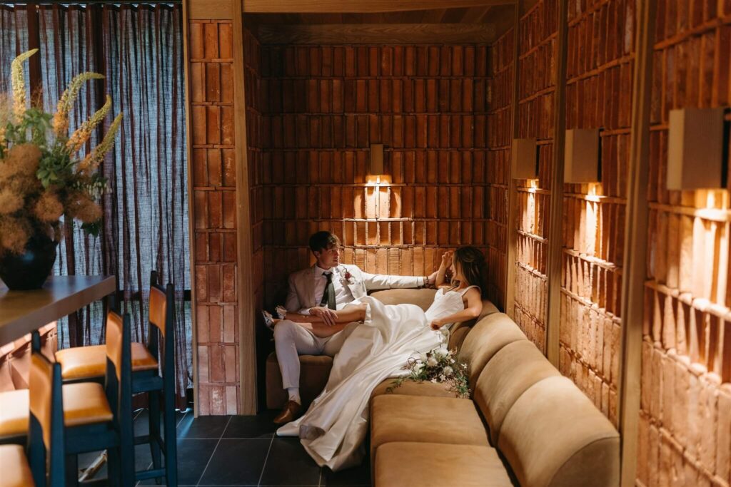 A newly married couple has an intimate moment at the bar inside of the MOLLIE Aspen wedding venue